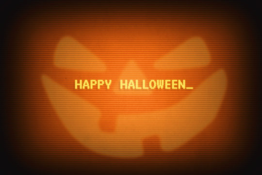 Happy halloween message and a smiling jack image on orange computer terminal screen