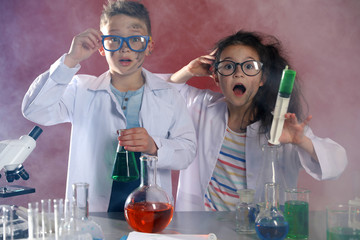 Children doing chemical research in laboratory. Dangerous experiment