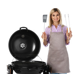 Woman in apron with barbecue grill and utensils on white background