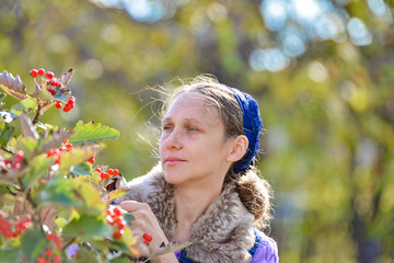 Portrait of a girl near a mountain ash, autumn sunny...