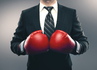Businessman in red boxing gloves