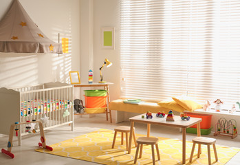 Cozy baby room interior with comfortable crib