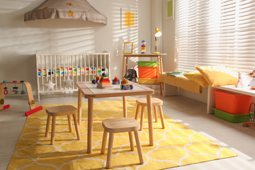 Cozy baby room interior with comfortable crib