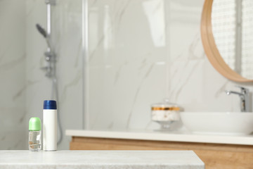 Obraz na płótnie Canvas Different deodorants on table in bathroom, space for text