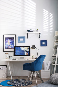 Home workplace with modern computer and desk in room