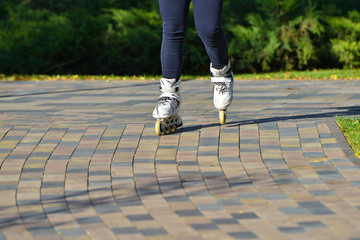The athlete rides a roller on the road in the park.