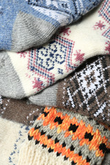 Fototapeta premium Different knitted woolen socks as background, closeup