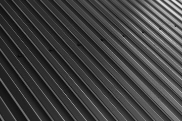 Black galvanized wall surface, diagonal view of textured background.