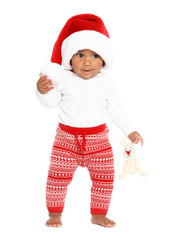 Festively dressed African-American baby with toy on white background. First Christmas