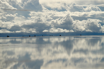 Mirages on the water? The Salar de Uyuni flooded after the rains, Bolivia. Clouds reflected in the water of the Salar de Uyuni, Bolivia