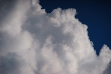Large white cumulus clouds against a blue sky.