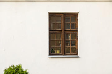 Fototapeta na wymiar Rectangular wooden window in white wall