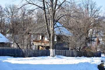 Wooden house in winter landscape in Romania