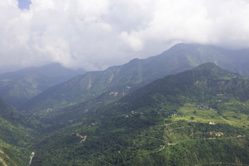 Green forest mountains landscape with clouds, copy space