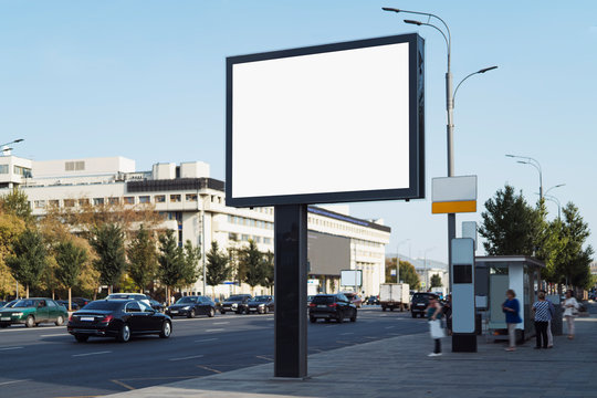 Horizontal digital banner near bus stop on busy road in city center. Drivers, passengers and pedestrians looking at commercial ads on billboard with big screen. Highway with several lanes, street lamp