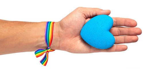 Man holds a heart in his hand. Rainbow ribbon LGBT pride. Gay with  blue heart. Isolated on a white background