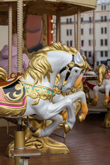 Horse carousel close-up. The head of a toy horse with a golden mane. Christmas scenery © OlgaKorica
