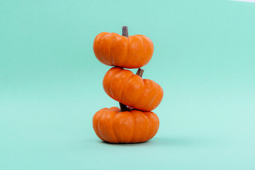 Pumpkins over neo mint background. Autumn, Halloween concept.Copy space for text.