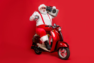 Portrait of his he nice bearded cheerful cheery carefree funky Santa wearing cap hat headwear...