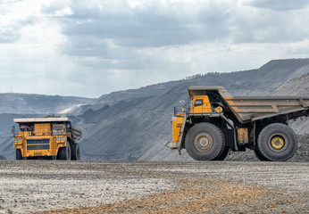 Obraz premium Rock transportation by dump trucks.