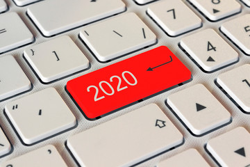 on the white keyboard a red button with the number 2020, the start of the new year