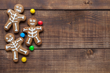 Halloween cookies on wood background, flat lay