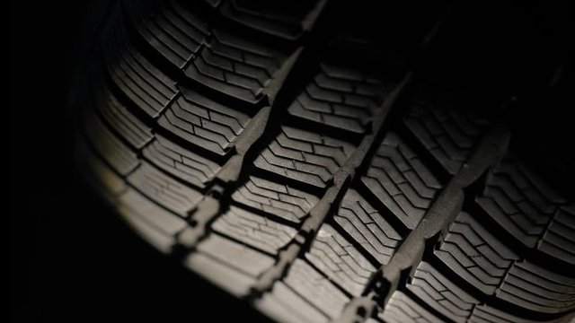 Spinning tire of a car slowly starting to roll