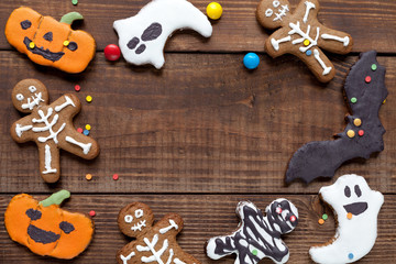 Halloween wood background with colorful cookies, flat lay