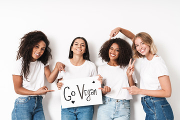 Friends posing isolated holding blank with motivation vegan text.
