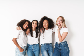 Cheery young women multiracial friends posing isolated