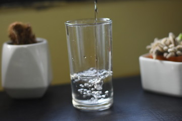 glass of water and candles on table
