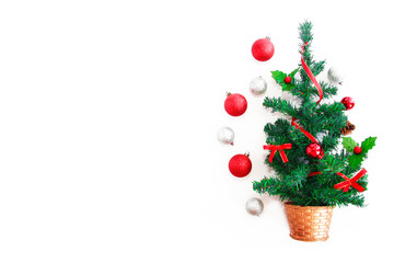 green christmas tree with multi-colored shiny toys balls for the holiday new year