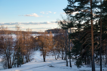 The steps on the lawn go down to the river on a winter day