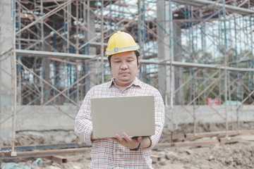 Engineer working on site, inspecting hands, using laptop site, construction concept, background construction concept