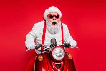 Portrait of nice attractive bearded crazy cheerful cheery funny funky Santa riding motor bike...