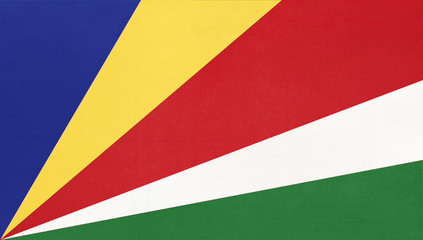 Seychelles island national fabric flag, textile background. Symbol of african world country.