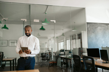 African American businessman working on a tablet in his office