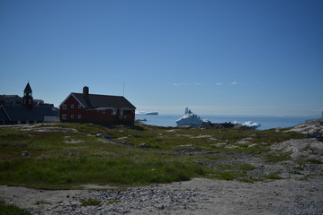 beautiful summer day in July in Ilulissat / view to the Disko Bay Greenland with buildings