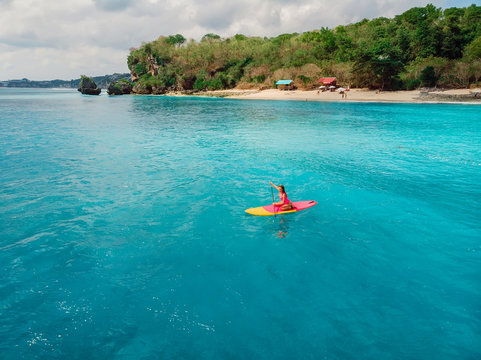 Attractive Woman On Stand Up Paddle Board On A Quiet Blue Ocean. Sup Surfing In Sea