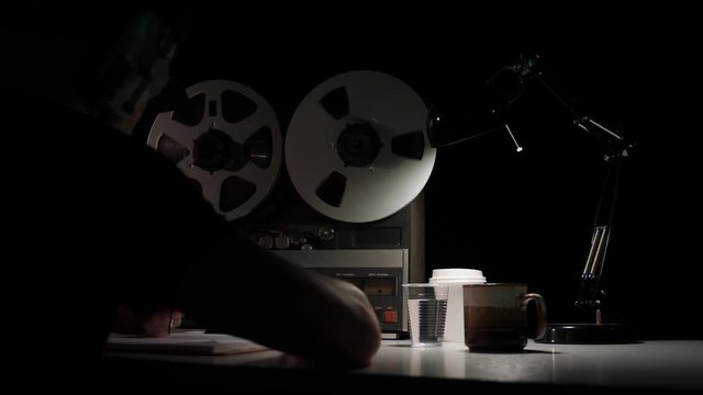  Retro Analog Quarter Inch Tape Recorder Being Operated in a Darkened Room