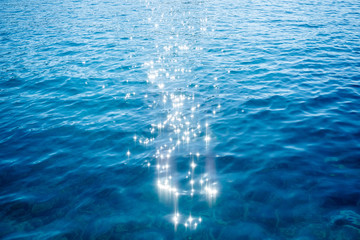 Blue sea surface background with splashing waves