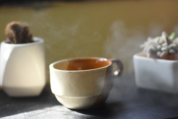 cup of tea and teapot on wooden table