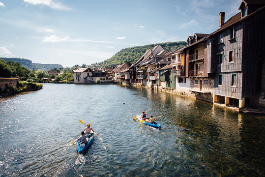 Des canoes kayaks sur la rivi&egrave;re la Loue &agrave; Ornans dans le Jura. Vacances sportives dans le Jura fran&ccedil;ais. La loue &agrave; Ornans. Une vieille ville de France. Naviguer sur une rivi&egrave;re.