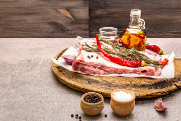 Raw pork ribs with rosemary, chili, garlic, salt and olive oil