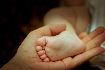 Newborn's foot in the palm of the hand
