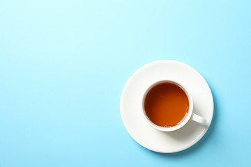 Cup of tea on blue background, copy space