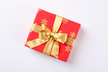 Beautiful gift box with golden bow on white background, space for text