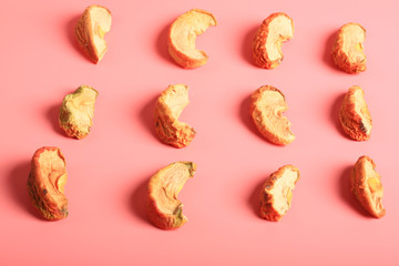 dried fruit apple snacks on a pink background with a shadow