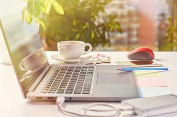 Laptop on a window background on a bright sunny day