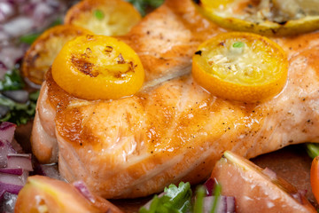 Grilled salmon and vegetables. Sprinkled with onions, dill and tomatoes.